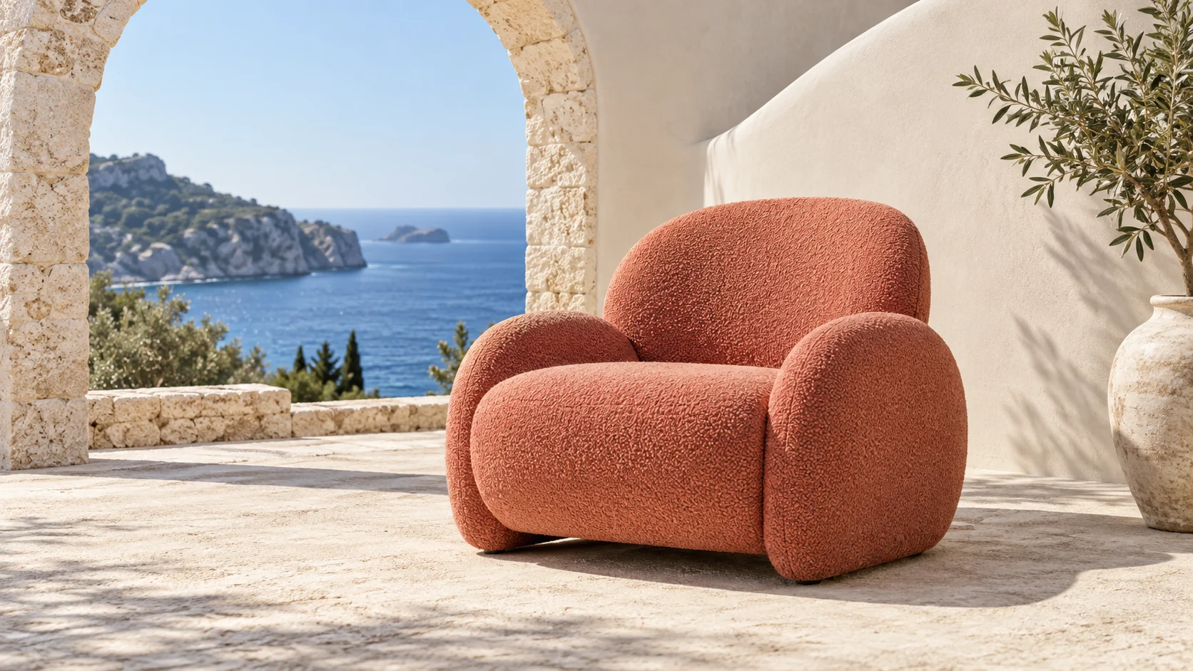 A terracotta lounge chair beneath a Mediterranean stone arch.
